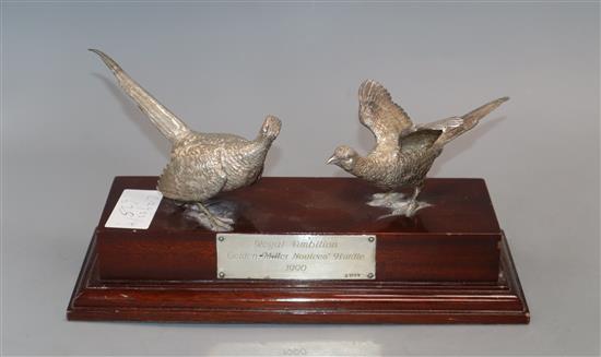 A modern silver presentation trophy modelled as two pheasants mounted on a wooden plinth, London, 1988, base 26cm.